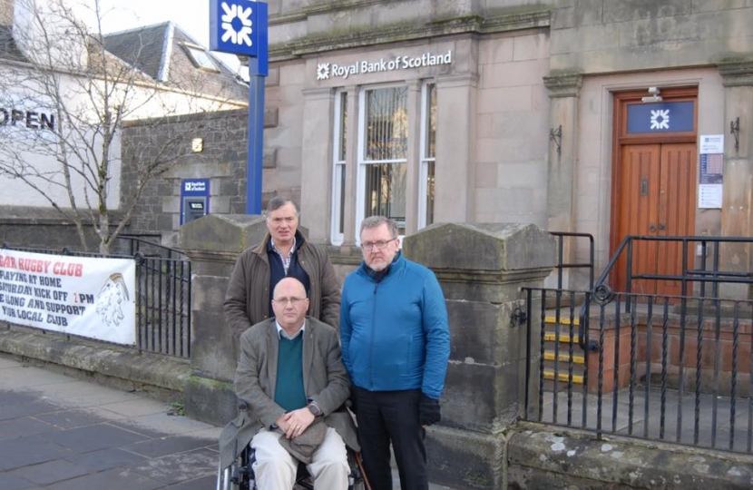 David Mundell MP (right), Cllr Alex Allison (left) and Cllr Eric Holford (front) campaigning to save Biggar's bank branch