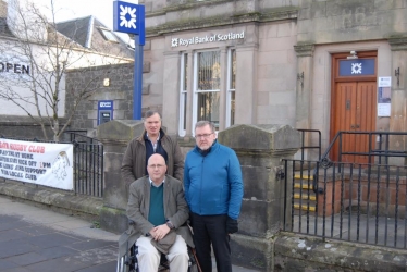 David Mundell MP (right), Cllr Alex Allison (left) and Cllr Eric Holford (front) campaigning to save Biggar's bank branch
